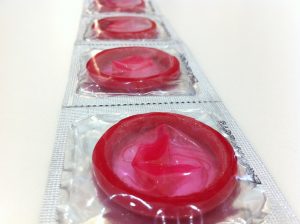 A line of clear-wrapped pink condoms