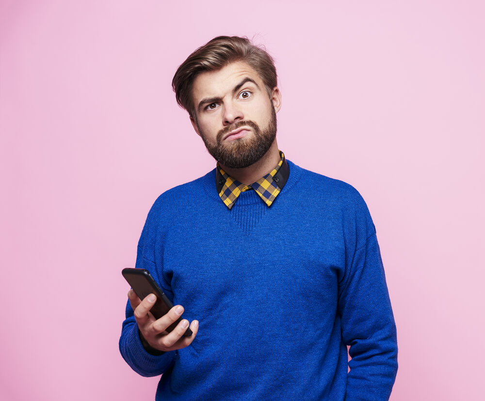 Amazed man with mobile phone